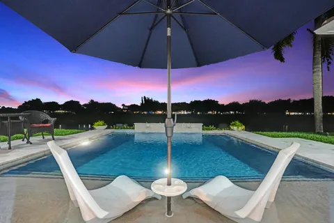 a view of a swimming pool with a yard