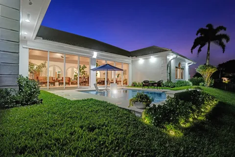 a view of a porch with chairs and backyard