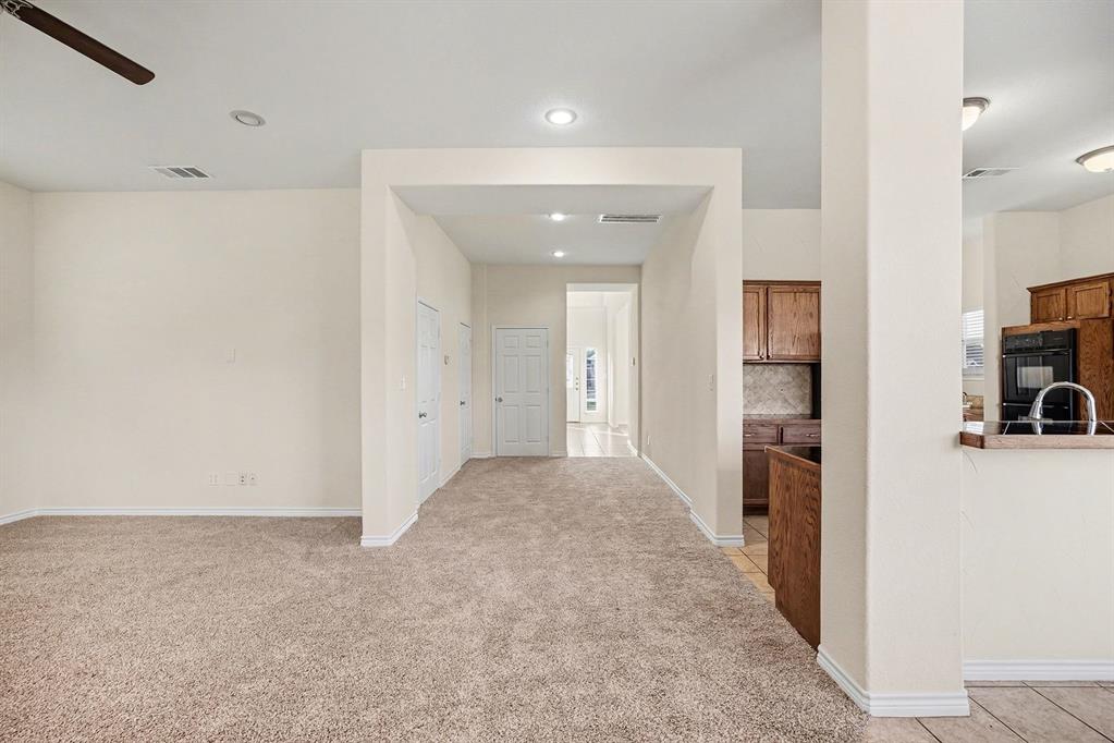 208 Cobblestone Circle Red Oak, TX 75154 - Photo 11 of 38 a view of a hallway with a dining table & chairs