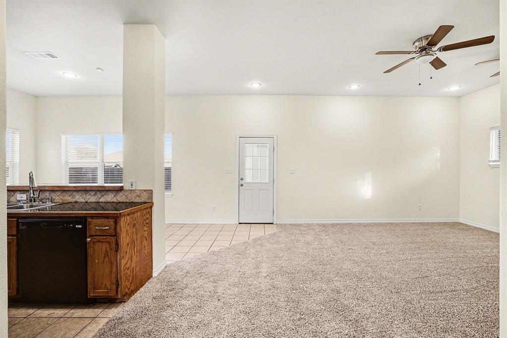 208 Cobblestone Circle Red Oak, TX 75154 - Photo 13 of 38 a view of a kitchen with a sink and a stove top oven