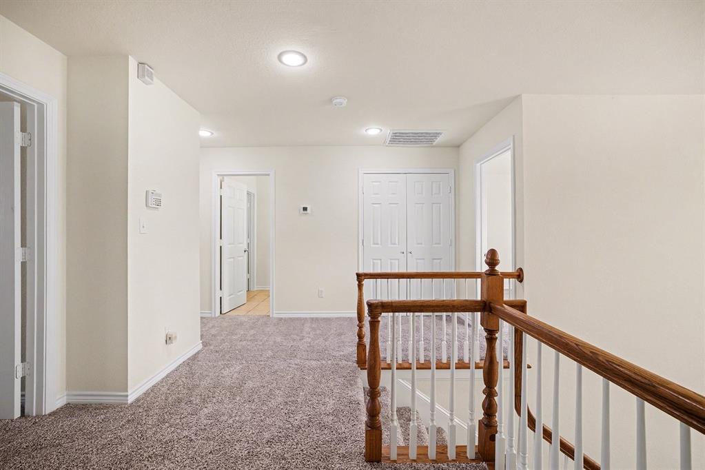 208 Cobblestone Circle Red Oak, TX 75154 - Photo 21 of 38 a view of a hallway with wooden floor