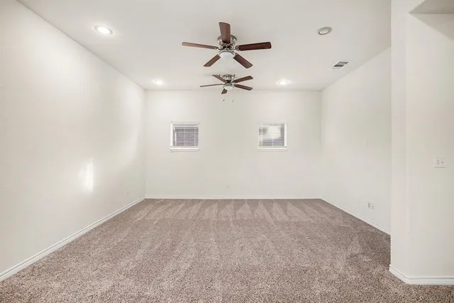a room with a stove a sink and a window