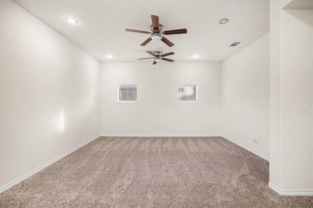 208 Cobblestone Circle Red Oak, TX 75154 - Photo 30 of 38 an empty room with a ceiling fan and wooden floor