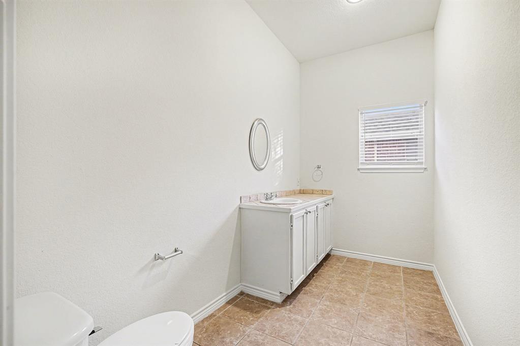 208 Cobblestone Circle Red Oak, TX 75154 - Photo 31 of 38 a room with a stove a sink and a window