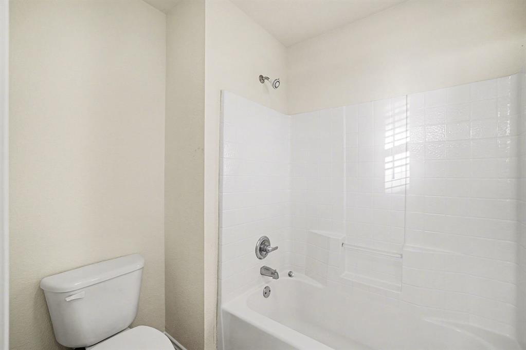208 Cobblestone Circle Red Oak, TX 75154 - Photo 34 of 38 a bathroom with a toilet and a bathtub