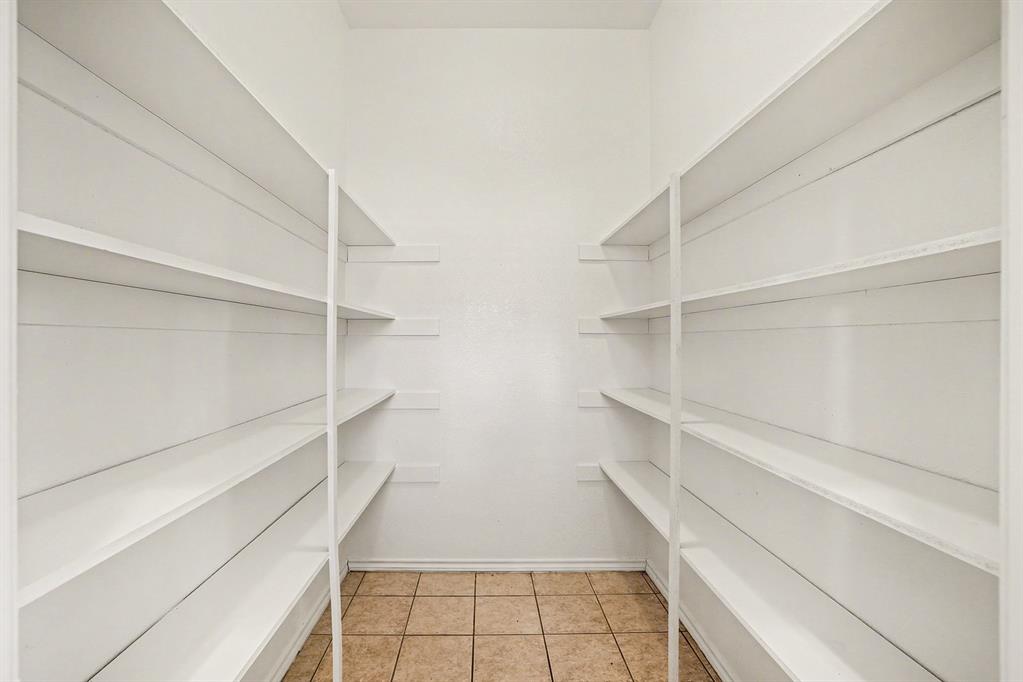 208 Cobblestone Circle Red Oak, TX 75154 - Photo 35 of 38 a view of walk in closet with empty racks