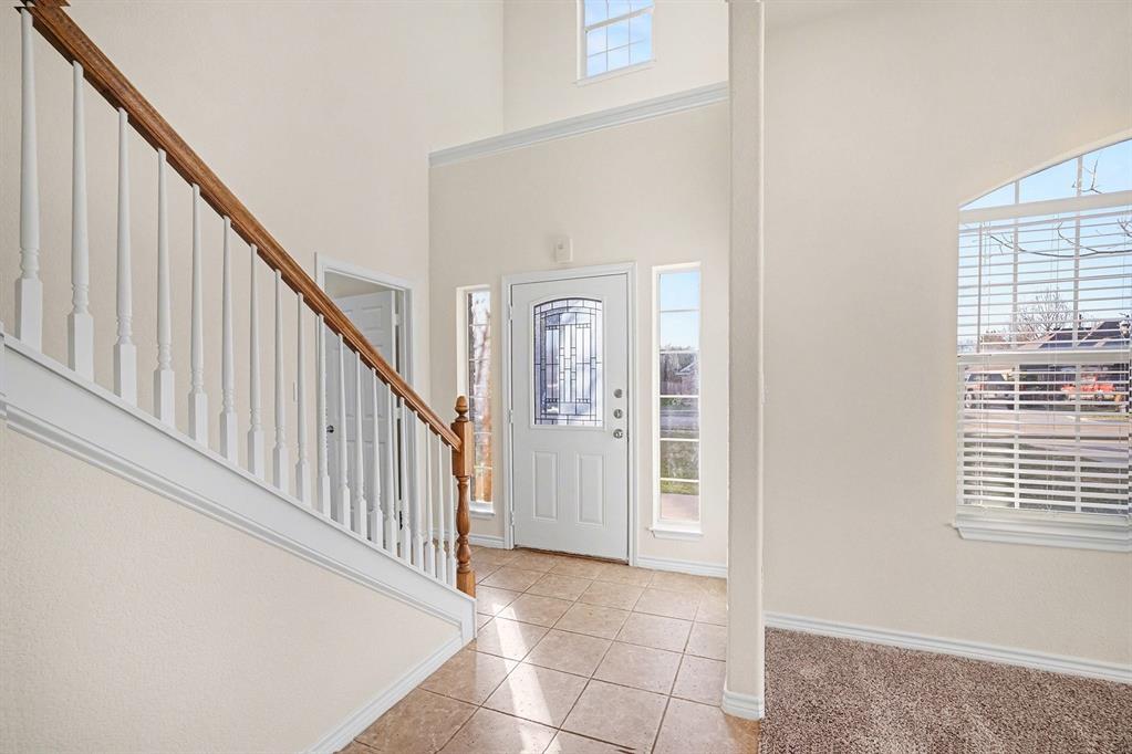 208 Cobblestone Circle Red Oak, TX 75154 - Photo 6 of 38 a view of staircase with white walls and a window