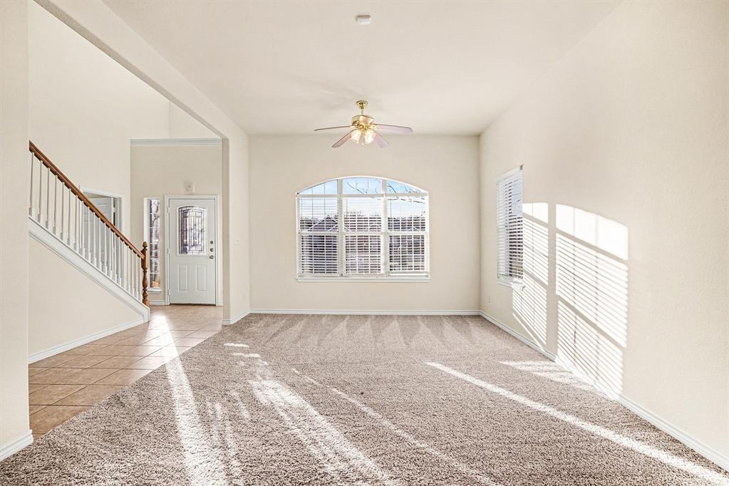 208 Cobblestone Circle Red Oak, TX 75154 - Photo 7 of 38 an empty room with windows and fan