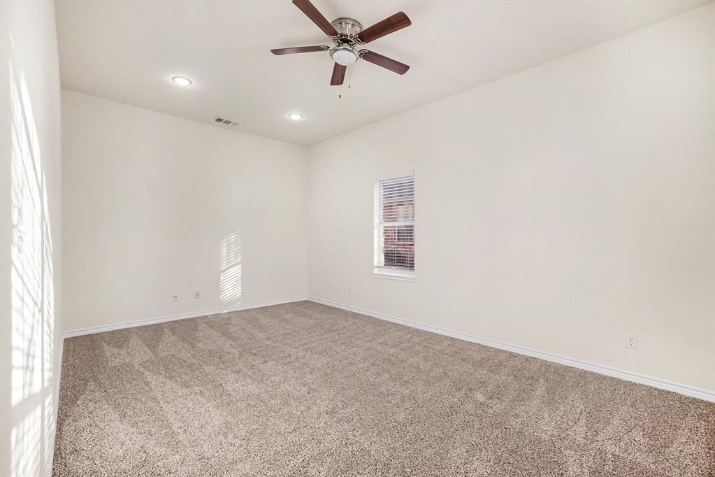 208 Cobblestone Circle Red Oak, TX 75154 - Photo 10 of 38 an empty room with windows and fan