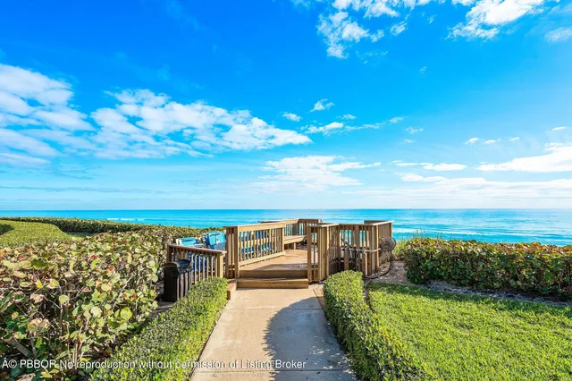 a view of a balcony with wooden floor and ocean view