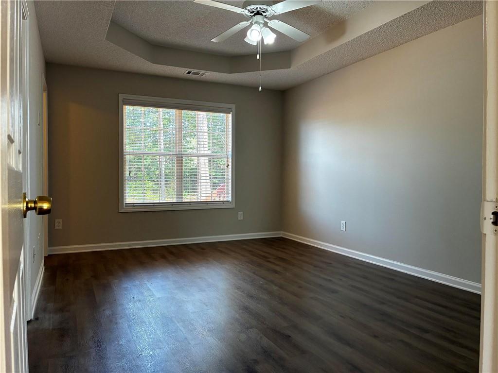 337 Madison Avenue Hampton, GA 30228 - Photo 17 of 32 a view of an empty room with wooden floor and a window