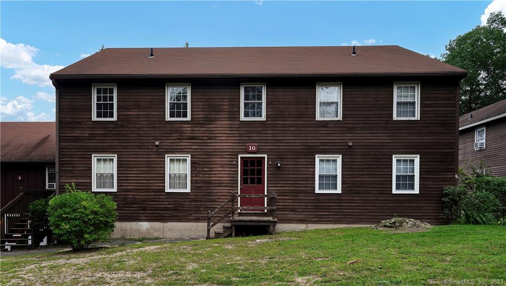 239 Old Farms Road, Unit 10C Avon, CT 06001 - Photo 1 of 1 a front view of a house with a garden