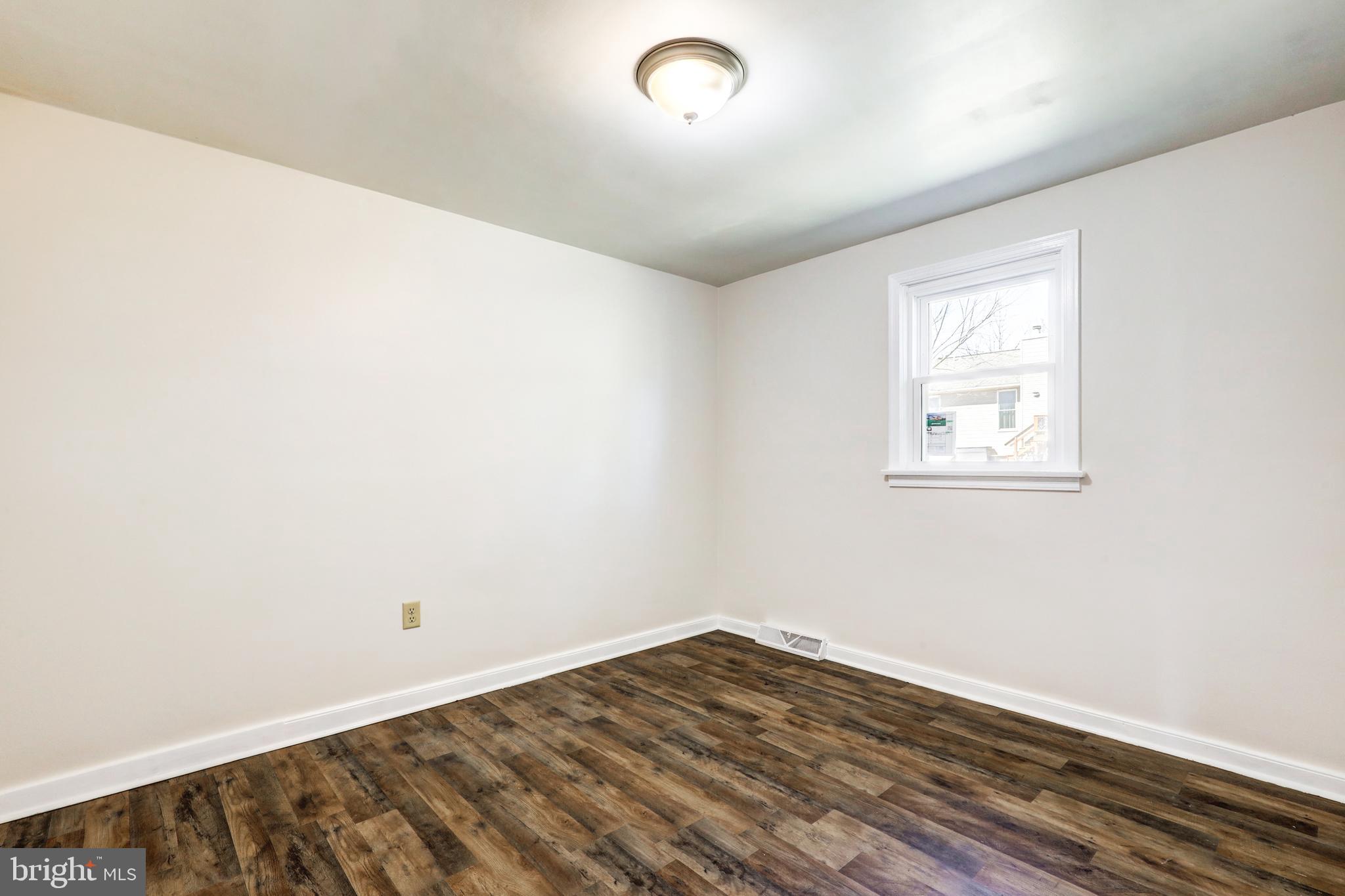 215 Akron Road Ephrata, PA 17522 - Photo 14 of 24 an empty room with wooden floor and windows