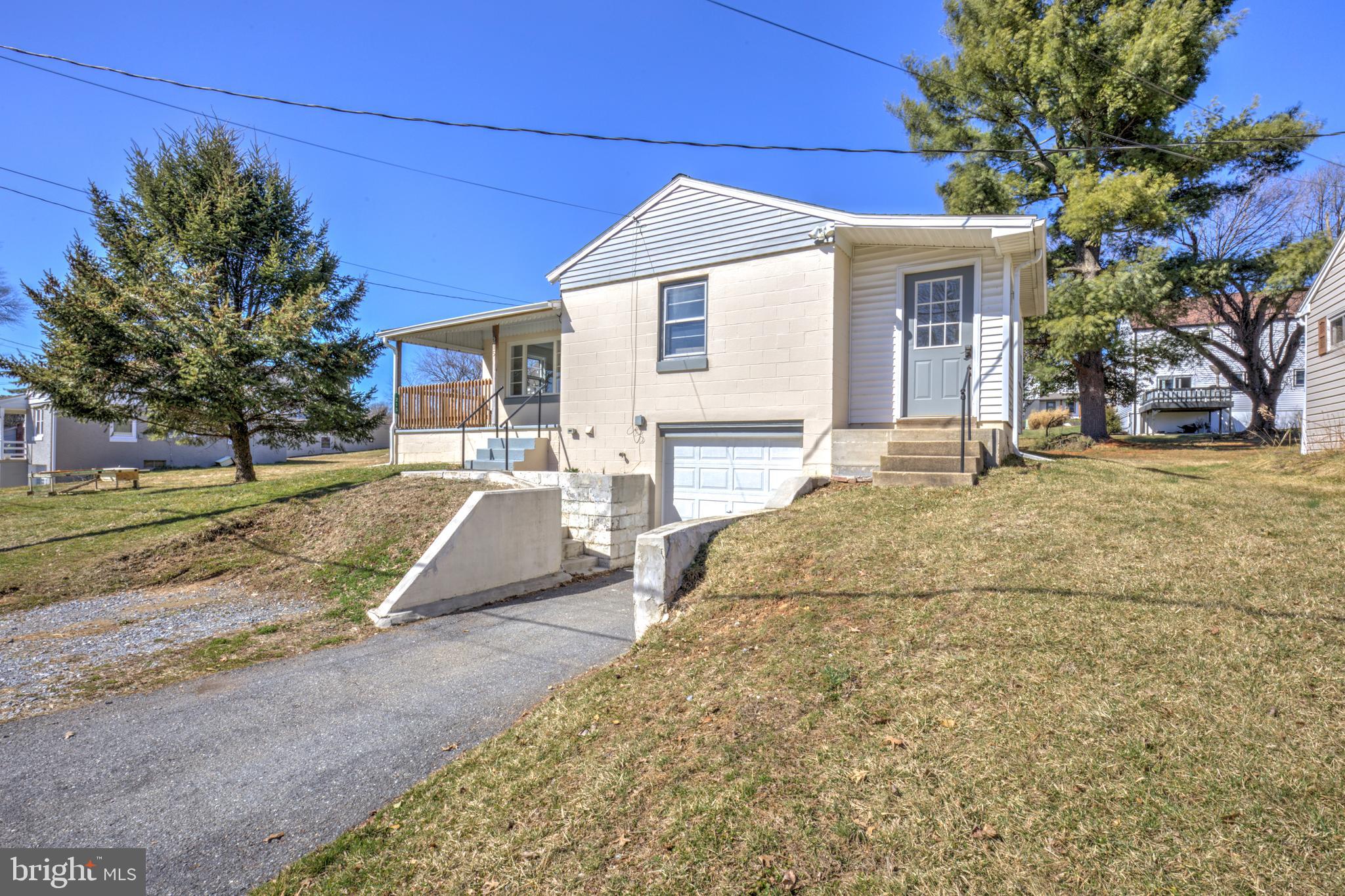 215 Akron Road Ephrata, PA 17522 - Photo 2 of 24 a front view of a house with a yard and garage