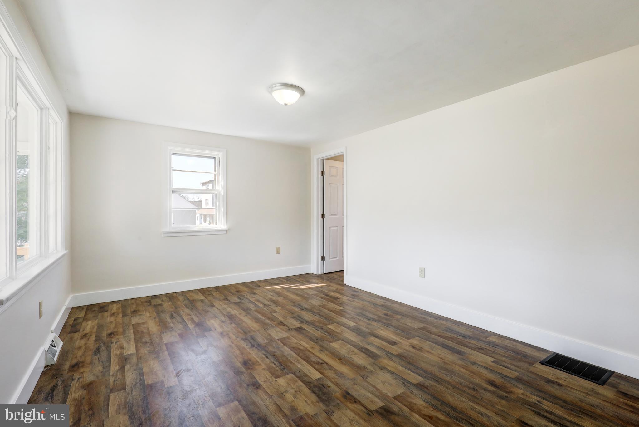 215 Akron Road Ephrata, PA 17522 - Photo 5 of 24 an empty room with wooden floor and windows