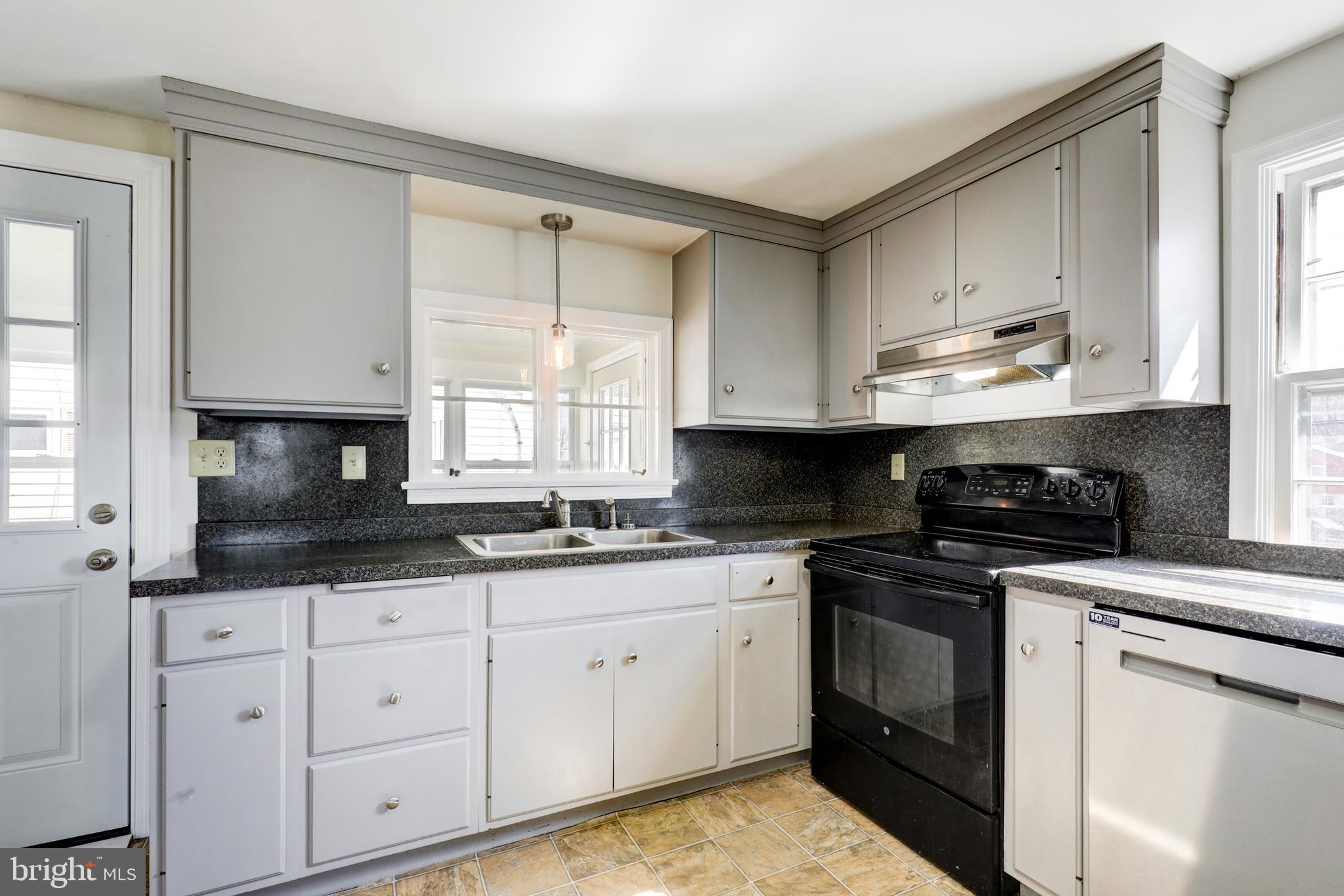 215 Akron Road Ephrata, PA 17522 - Photo 9 of 24 a kitchen with granite countertop white cabinets sink and stainless steel appliances