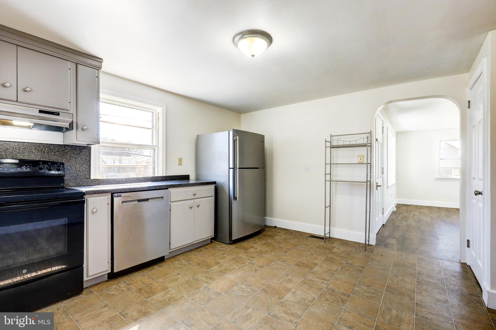 215 Akron Road Ephrata, PA 17522 - Photo 10 of 24 a kitchen with granite countertop a refrigerator and a stove top oven