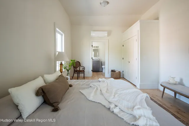 a bedroom with a bed and a couch
