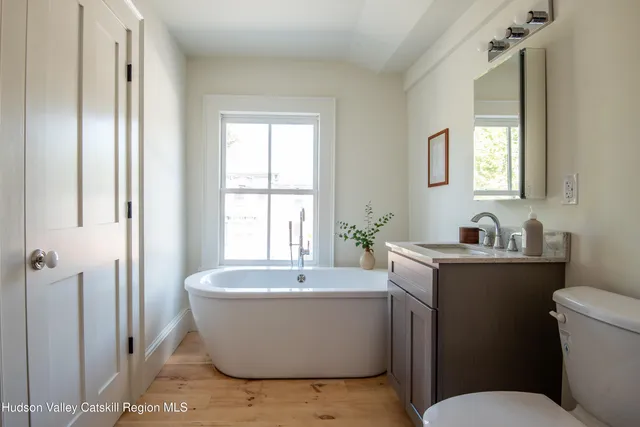 a white bath tub sitting next to a white sink