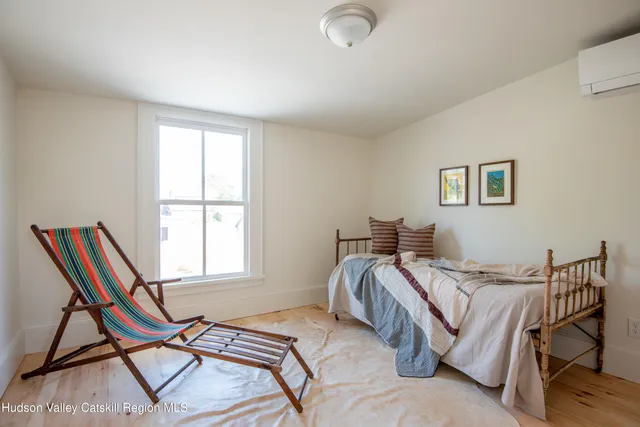 a bed sitting in a bedroom next to a window