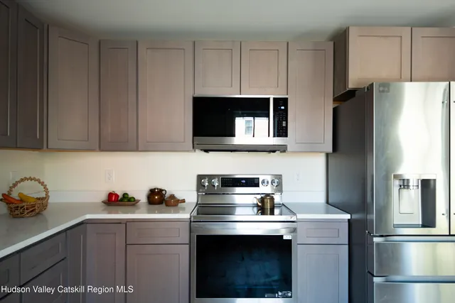 a kitchen with stainless steel appliances a sink cabinets and a refrigerator