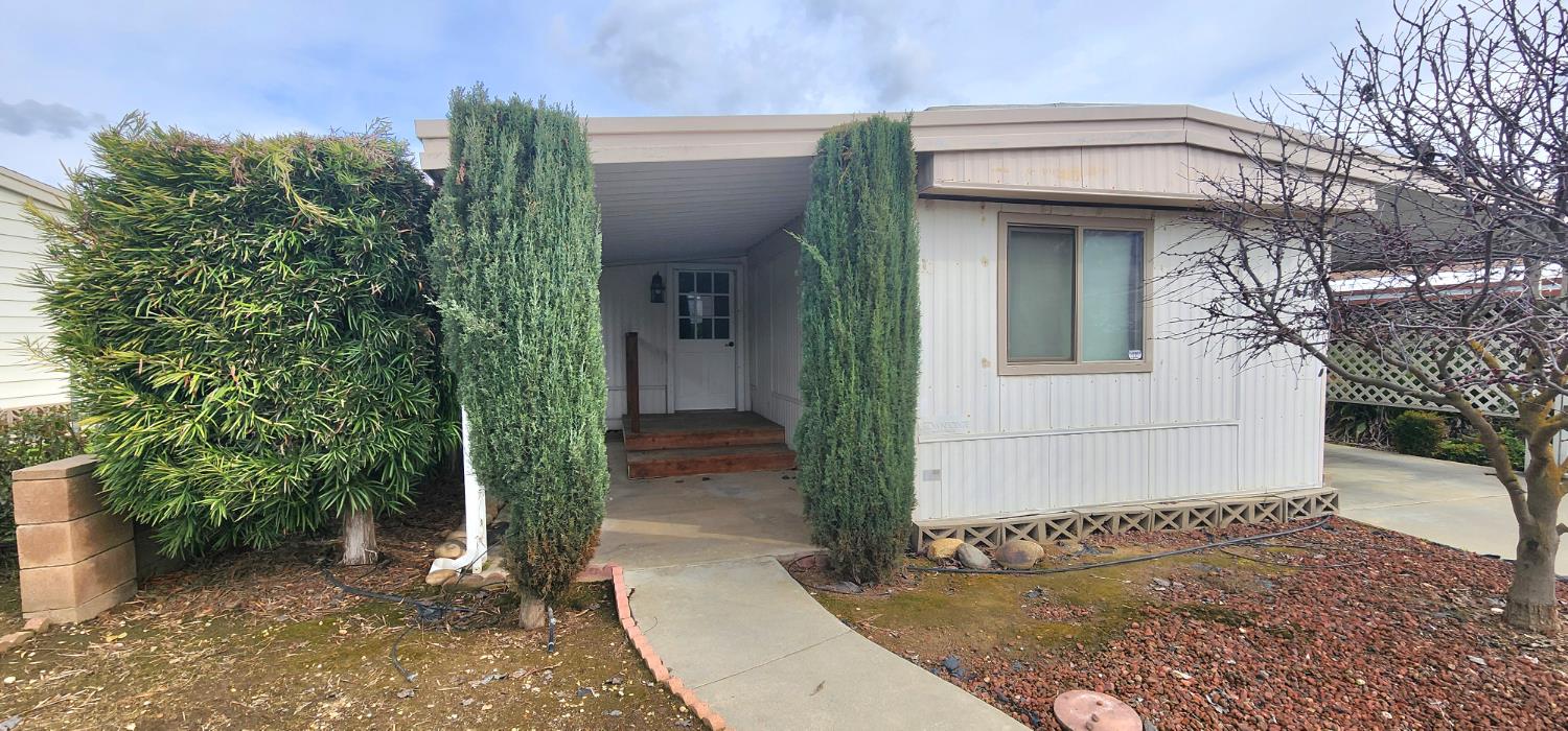 a view of a house with potted plants