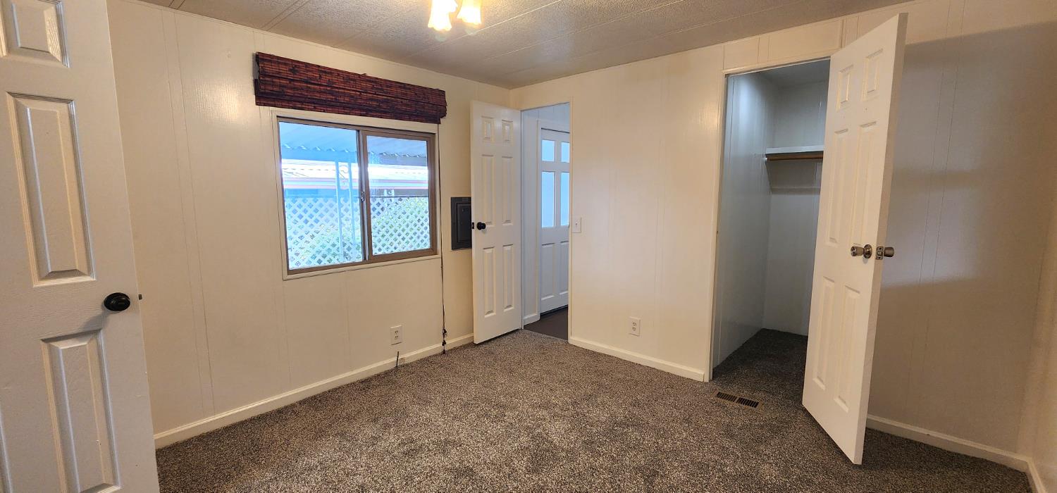 1300 West Olson Avenue, Unit 179 Reedley, CA 93654 - Photo 13 of 39 a view of an empty room with closet and a window
