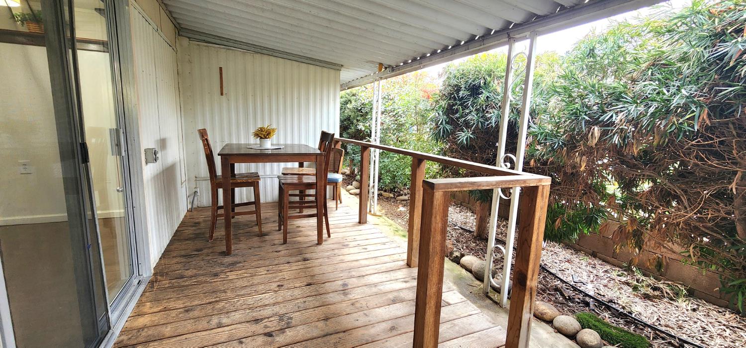 1300 West Olson Avenue, Unit 179 Reedley, CA 93654 - Photo 16 of 39 a view of a balcony with chairs and wooden floor
