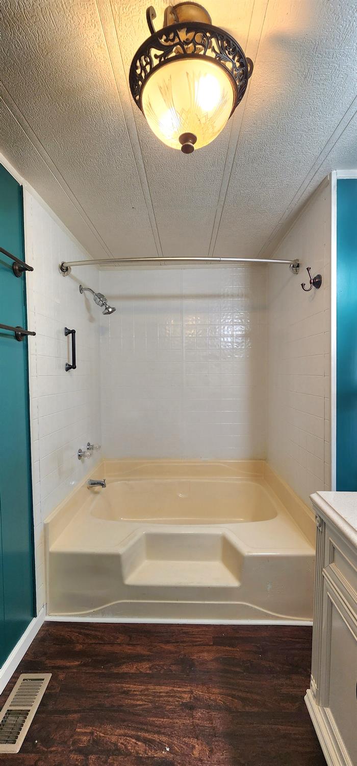 1300 West Olson Avenue, Unit 179 Reedley, CA 93654 - Photo 17 of 39 a bathroom with a bathtub and shower