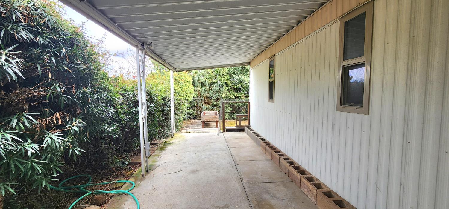 1300 West Olson Avenue, Unit 179 Reedley, CA 93654 - Photo 18 of 39 a porch with chairs and wooden floor