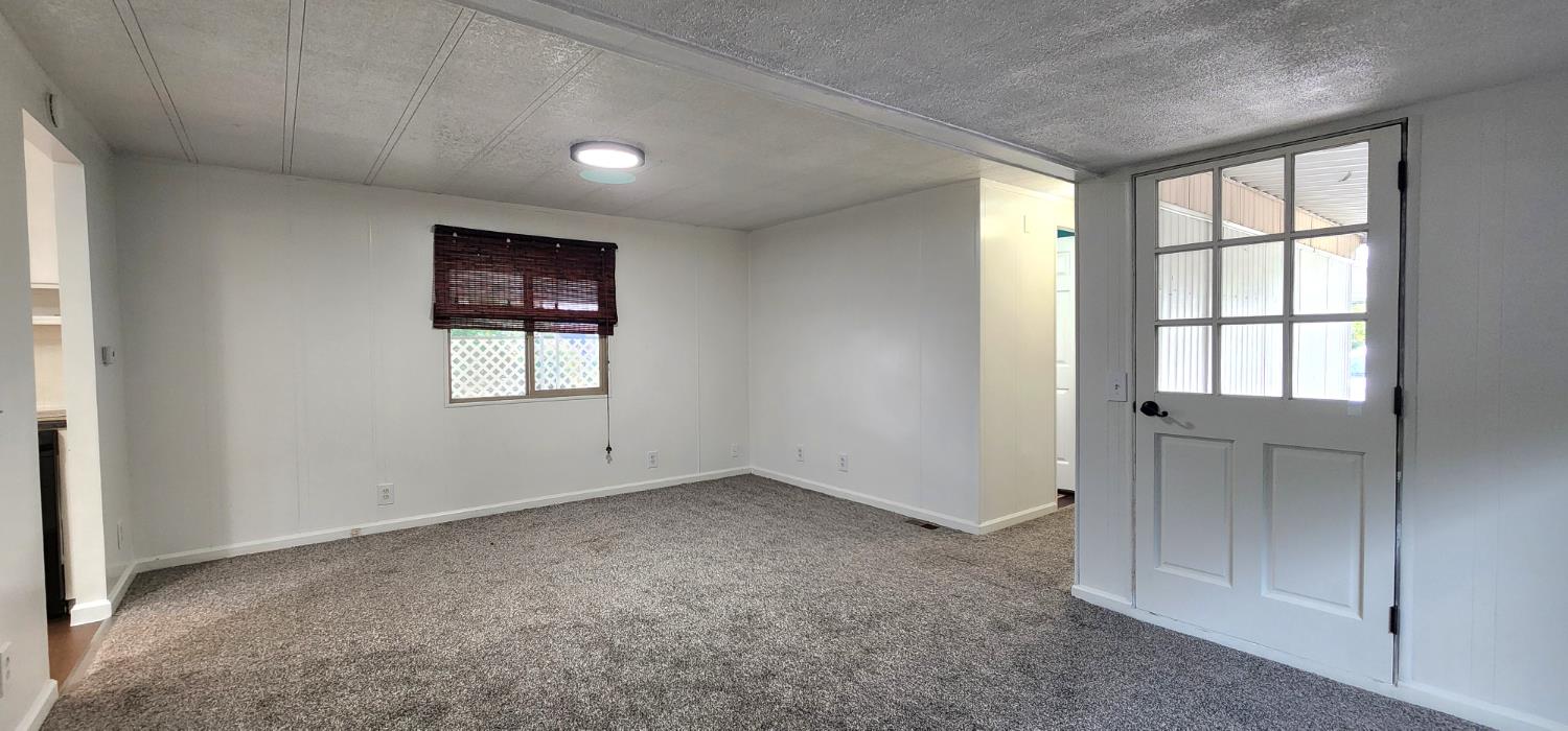 1300 West Olson Avenue, Unit 179 Reedley, CA 93654 - Photo 19 of 39 an empty room with windows and closet