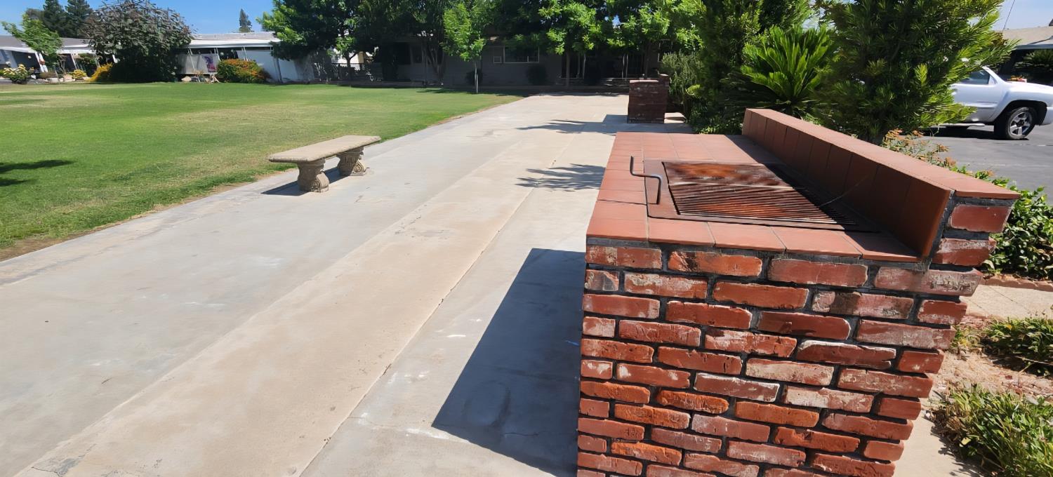 1300 West Olson Avenue, Unit 179 Reedley, CA 93654 - Photo 34 of 39 a view of a patio with a yard