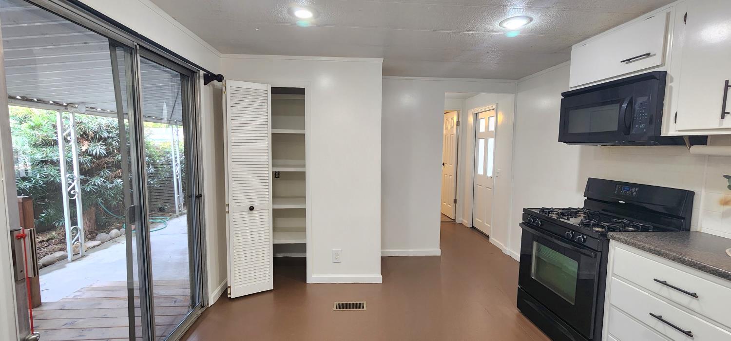1300 West Olson Avenue, Unit 179 Reedley, CA 93654 - Photo 34 of 39 a kitchen with stainless steel appliances granite countertop a refrigerator a stove top oven a sink and dishwasher