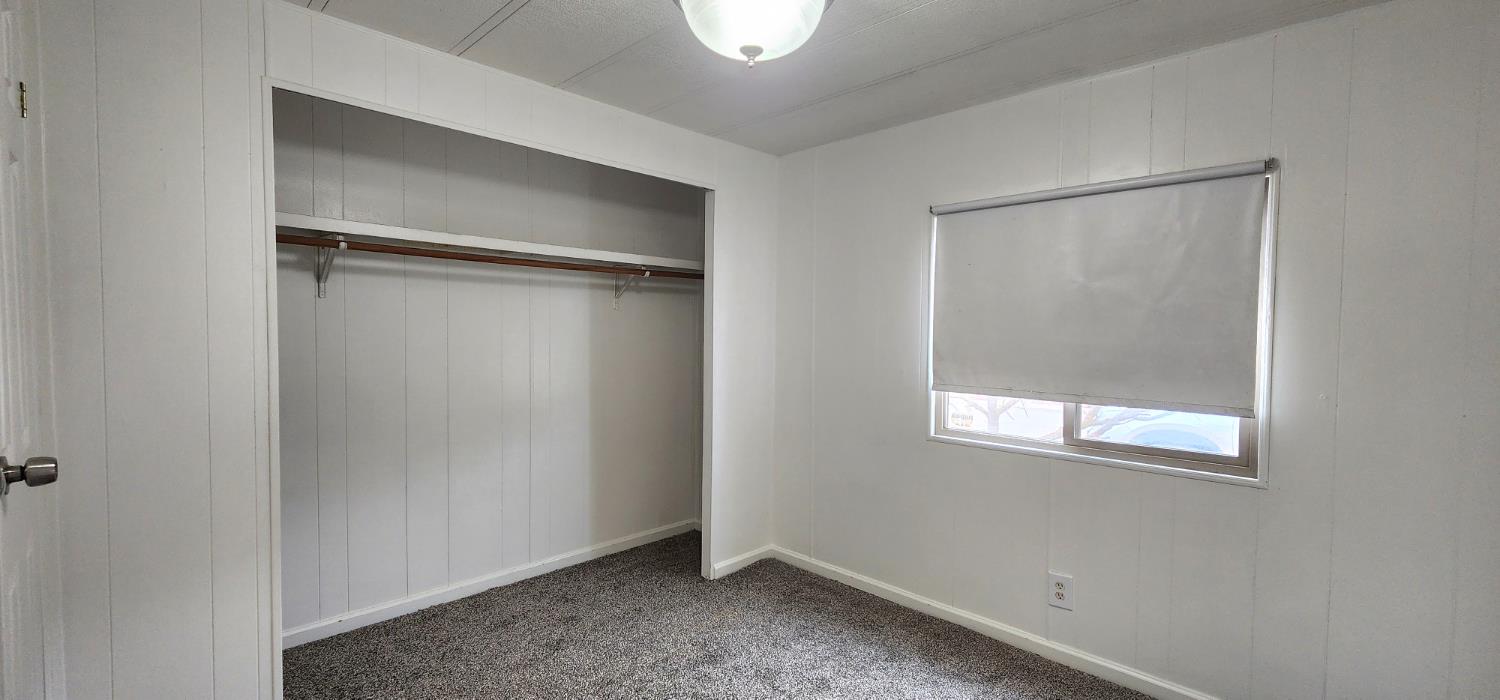 1300 West Olson Avenue, Unit 179 Reedley, CA 93654 - Photo 9 of 39 a view of an empty room with a window
