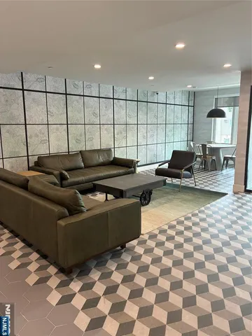 a living room with lots of furniture and a window