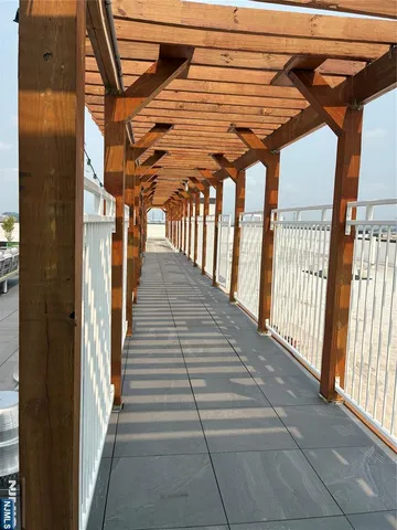 a living room with couches and large potted plants