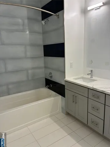 a bathroom with a bathtub and a sink