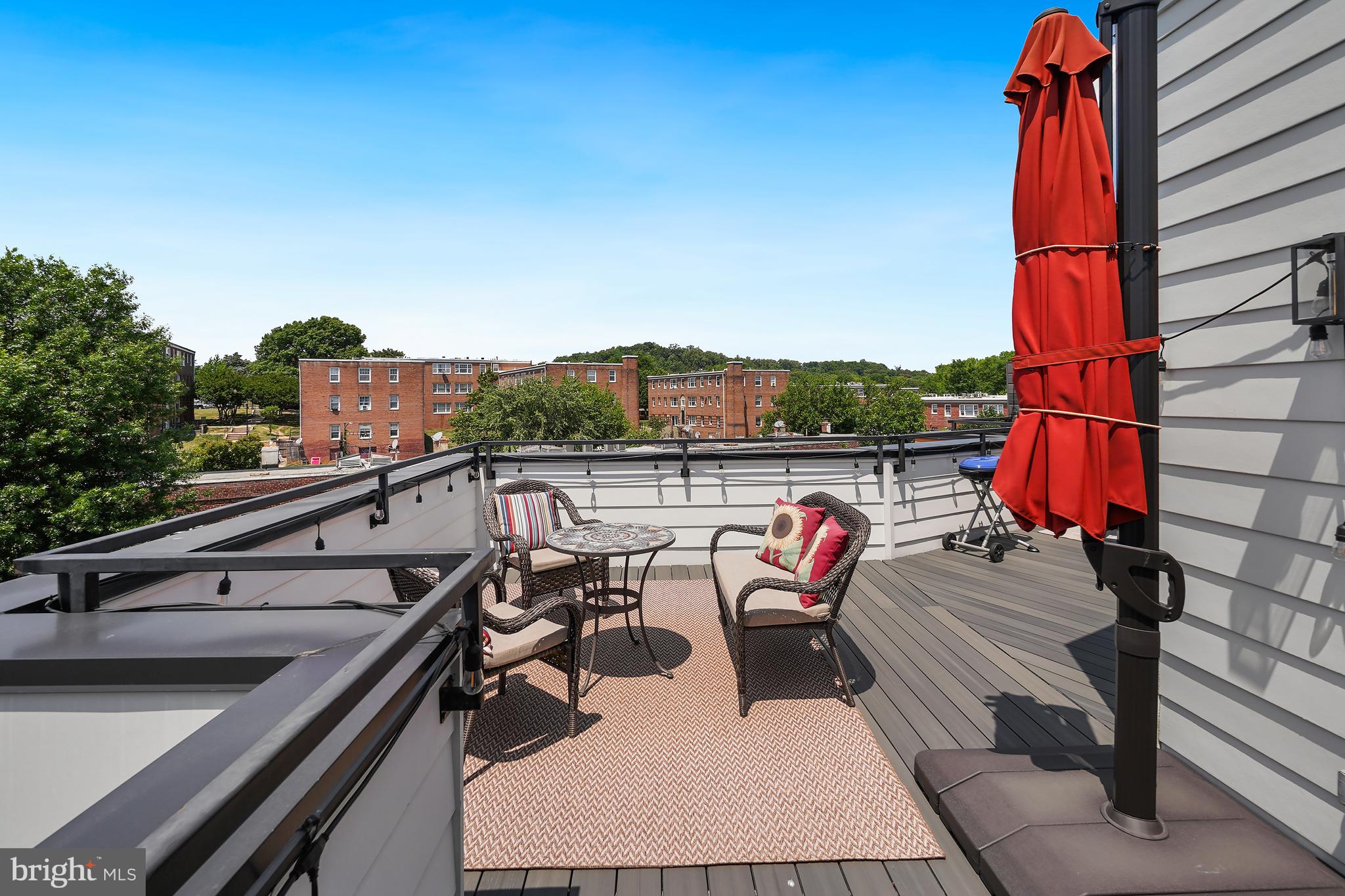 2001 I Street Northeast, Unit 10 Washington, DC 20002 - Photo 4 of 6 a terrace with outdoor seating and trees in the background