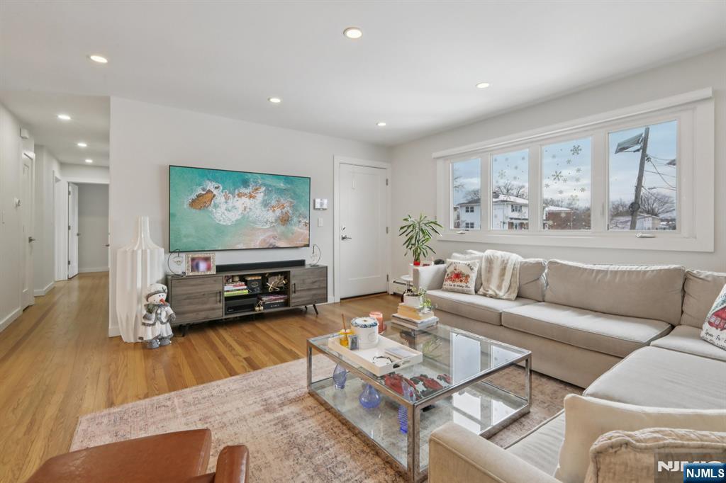 10 Millo Place, Unit 1 Little Ferry, NJ 07643 - Photo 11 of 42 a living room with furniture and a flat screen tv