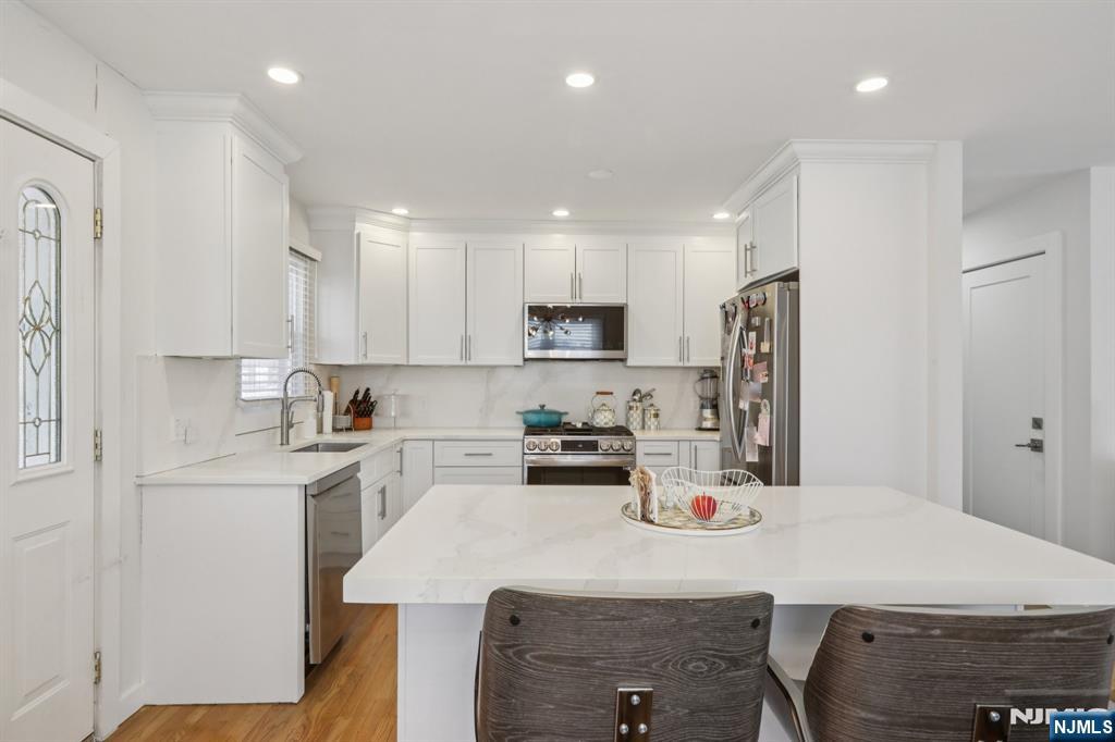 10 Millo Place, Unit 1 Little Ferry, NJ 07643 - Photo 17 of 42 a kitchen with refrigerator and cabinets