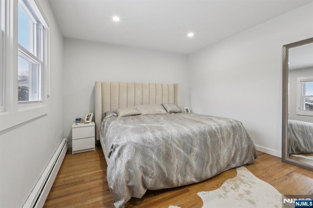 10 Millo Place, Unit 1 Little Ferry, NJ 07643 - Photo 24 of 42 a bed sitting in a bedroom next to a window