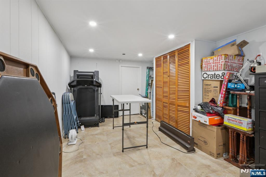 10 Millo Place, Unit 1 Little Ferry, NJ 07643 - Photo 31 of 42 a room with furniture and a flat screen tv