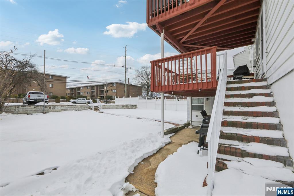 10 Millo Place, Unit 1 Little Ferry, NJ 07643 - Photo 37 of 42 a room with lots of white furniture and a chandelier