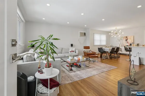 a living room with lots of furniture and view of kitchen