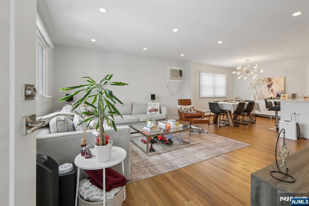 10 Millo Place, Unit 1 Little Ferry, NJ 07643 - Photo 7 of 42 a living room with lots of furniture and view of kitchen