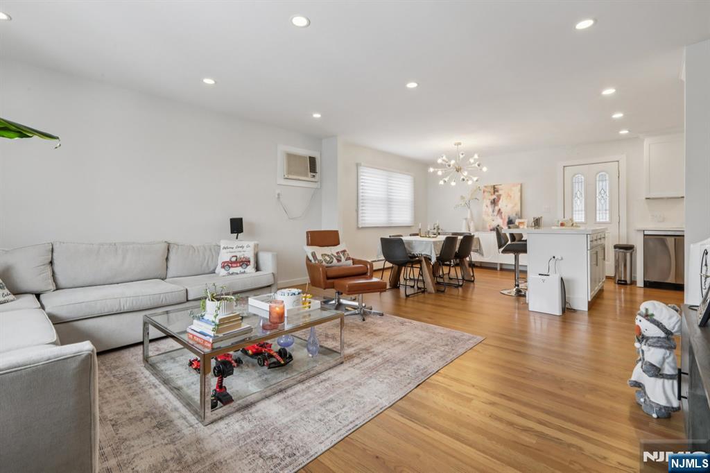 10 Millo Place, Unit 1 Little Ferry, NJ 07643 - Photo 8 of 42 a living room with furniture a wooden floor and next to a window