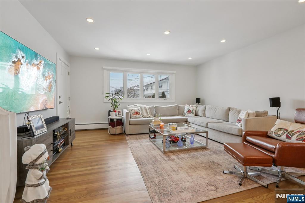 10 Millo Place, Unit 1 Little Ferry, NJ 07643 - Photo 9 of 42 a living room with furniture and a flat screen tv