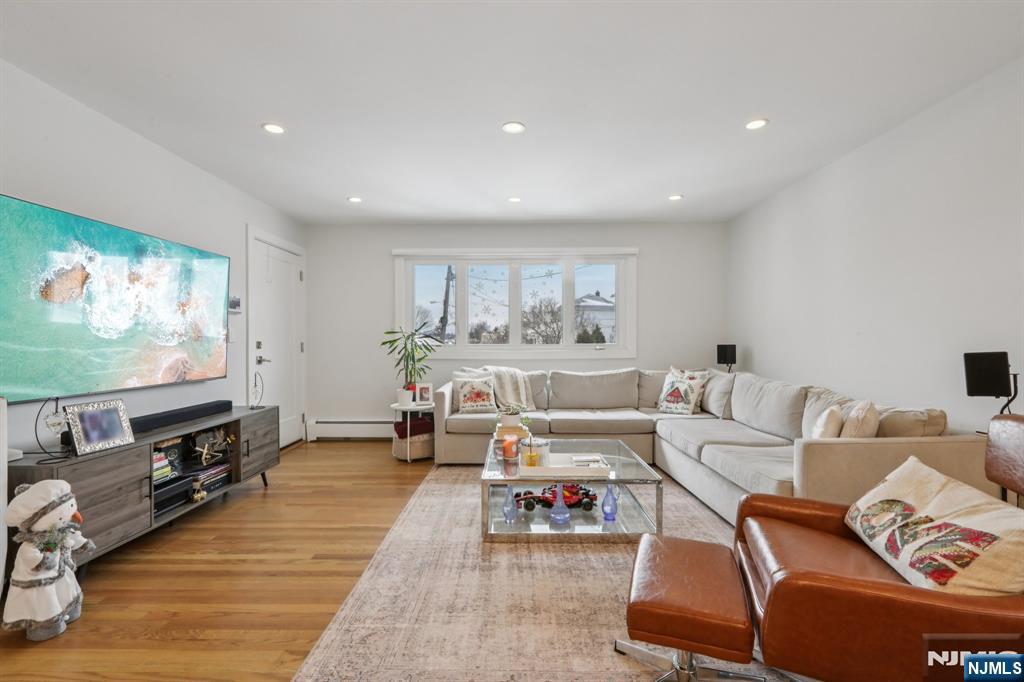 10 Millo Place, Unit 1 Little Ferry, NJ 07643 - Photo 10 of 42 a living room with furniture and a flat screen tv