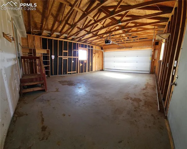 a view of empty room with wooden walls