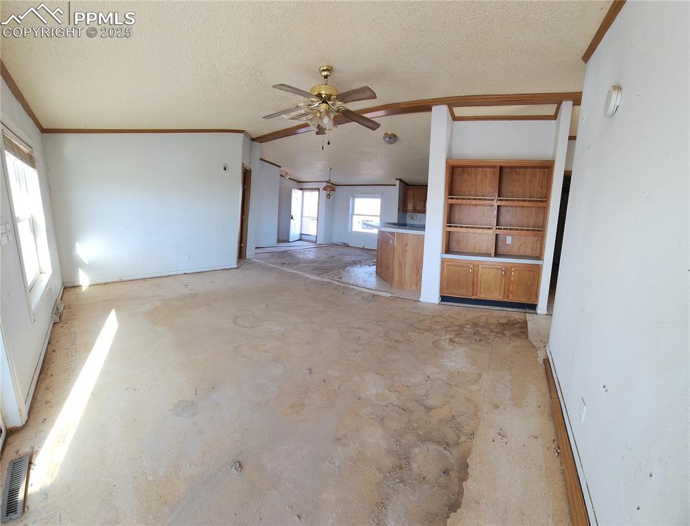 5510 Whipshaw Road Peyton, CO 80831 - Photo 6 of 18 an empty room with chandelier fan and windows